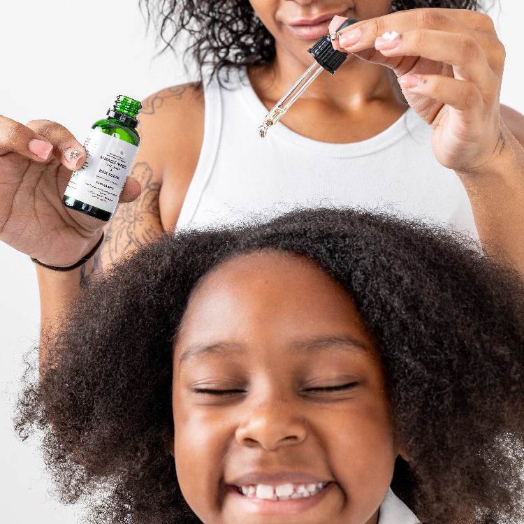 mother dropping serum on smiling childs scalp