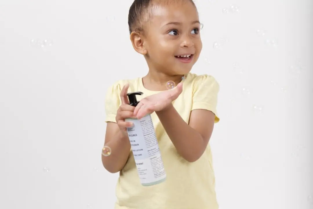 A smiling child using a family-care product pump.
